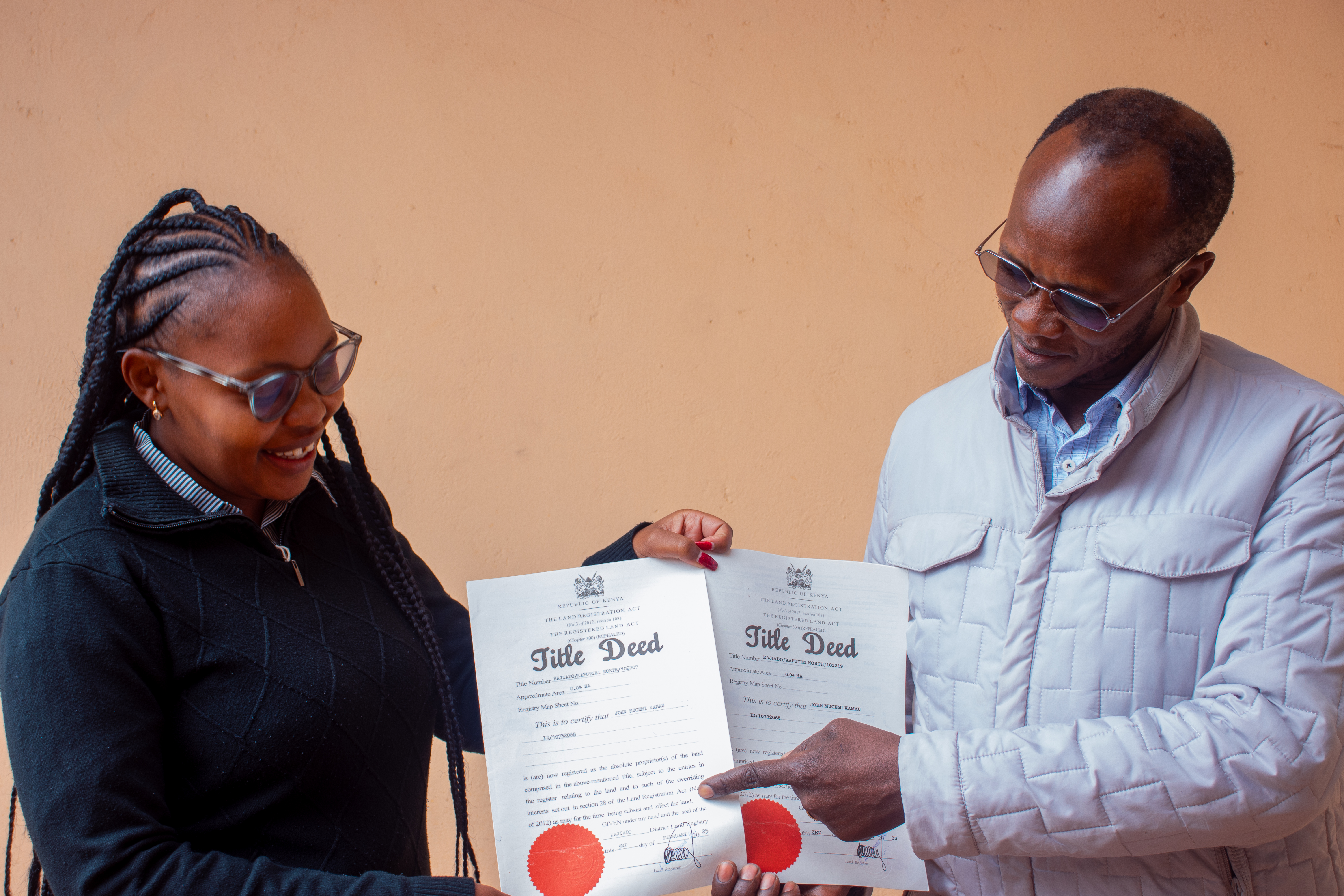 Legal Officer, Ms. Anastasia Kemunto handing over to client